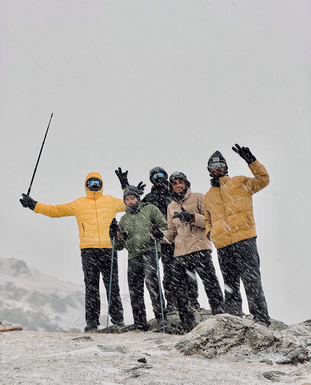 A group celebrating on the snowy summit