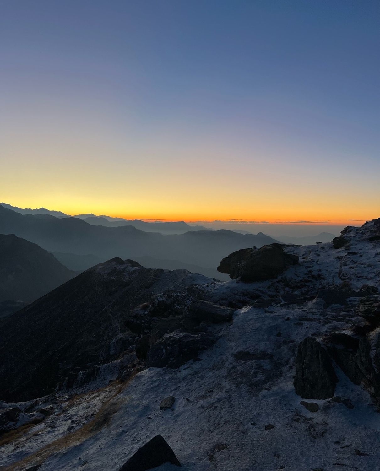 Sunrise glowing over the mountains from the summit